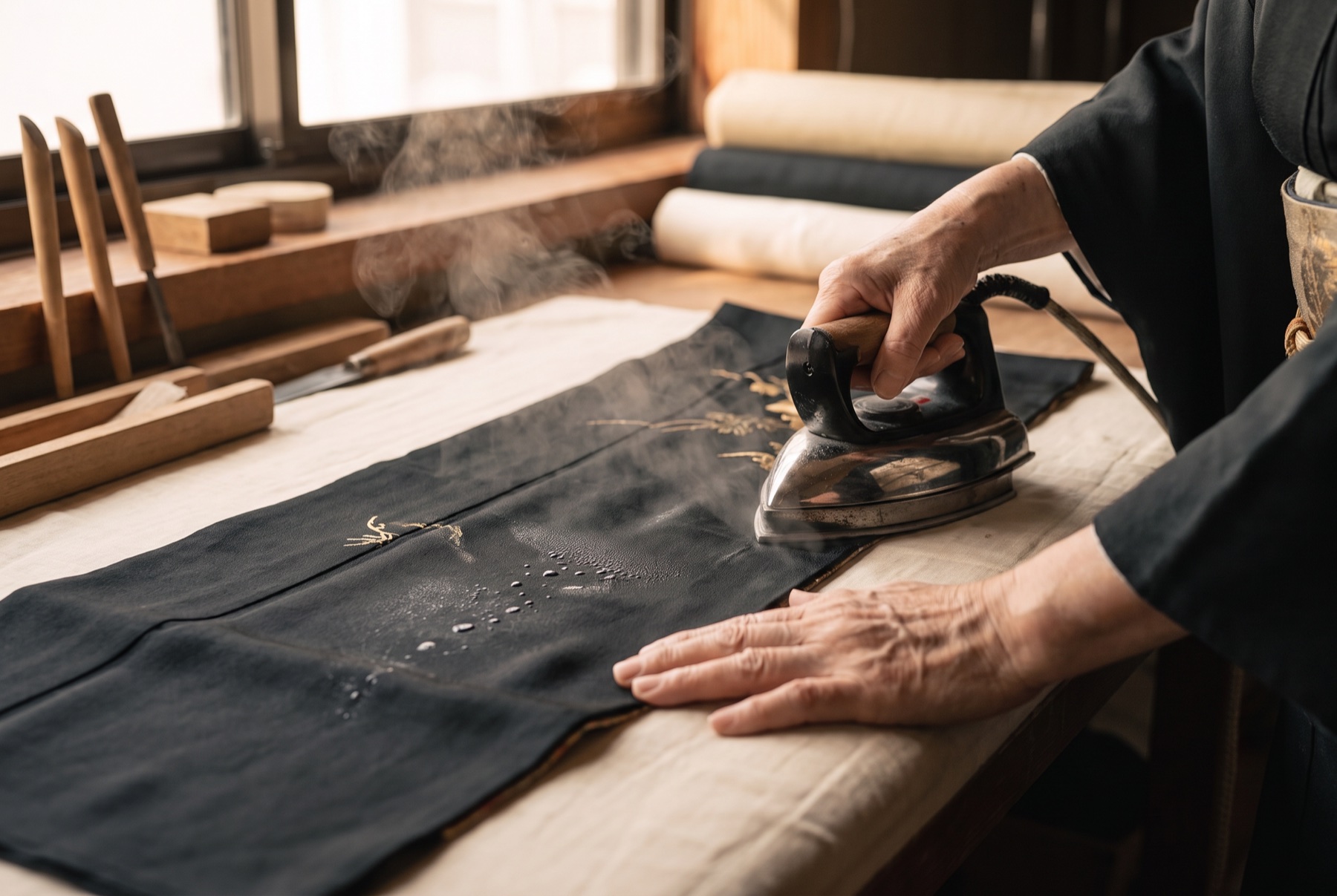 Pressing washed black silk to release the fold-lines